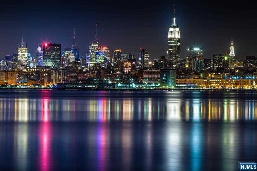 This majestic property is in the most prestigious Kings Bluff section of Weehawken Palisades with bonus unobstructed views from several oversized picture windows of the most iconic skyline in the world. This home boasts over 3000 SF of living space; 7 bedrooms with an extra large master bedroom suite & walk-in closet , 5.5 bathrooms, 3 zone central A/C, exceptionally large living room, Two modern kitchen with S/S appliances, huge formal dining room, breakfast room with lots of windows, family room, with 2 additional rooms for office room or sitting room & nursery, lots of closets & large storage space in oversized attic plus large outside room. The inviting outdoor porch off dining room beckons one to relax & enjoy the beauty of the river & skyline. Attached is a 2-car garage plus an oversized Belgium block driveway that fits 4+ car parking spaces. This property can be used as a large one family with four floors of open concept living space, or to use legal two family own access.