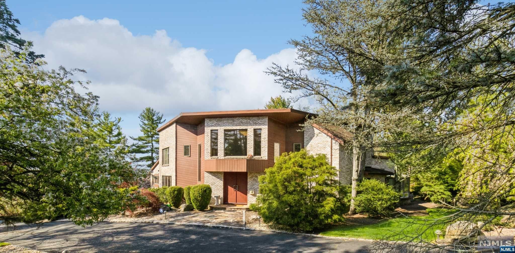 1+ ACRE in MOST Prestigious CHESTNUT HILL. Be WOWED by this Forever-in-Demand CONTEMPORARY known for its GREAT ROOM w/High CATHEDRAL Ceiling, Tons of NATURAL LIGHT, GRAND2-Story Foyer & Upstairs "BRIDGE". WELL MAINTAINED & BOASTING Over 6500+ Sq ft of Livings Space incl. WALK-OUT Basement, 5 Bedrooms (2 Master En-SUITES) and 5 1/2 Bathrooms. Main Floor 850+ sqft Master En-Suite #1 with SPA-LIKE Bath, 2 Walk-In Closets & SLIDER out to Deck. GREAT ROOM WITH MARBLE FACED Fireplace and Walk-out to Deck is Open to Formal Dining Room. Front to Back 400 sq ft EAT-IN Custom Kitchen with New SUB-ZERO Fridge & VIKING Cooktop. Main Level Private Guest Bedroom/Office and Full bathroom with Easy access to outdoor HOT TUB. 2nd Level Hosts 300 SQ FT Master En-Suite #2 , +2 additional Nice Sized bedrooms.1600+ sq ft finished basement w/WALKOUT to PATIO & LUSH PRIVATE grounds & includes Media Room/Rec room, Office/Bedroom, Exercise room, Bonus room& entry to 3 Car garage.