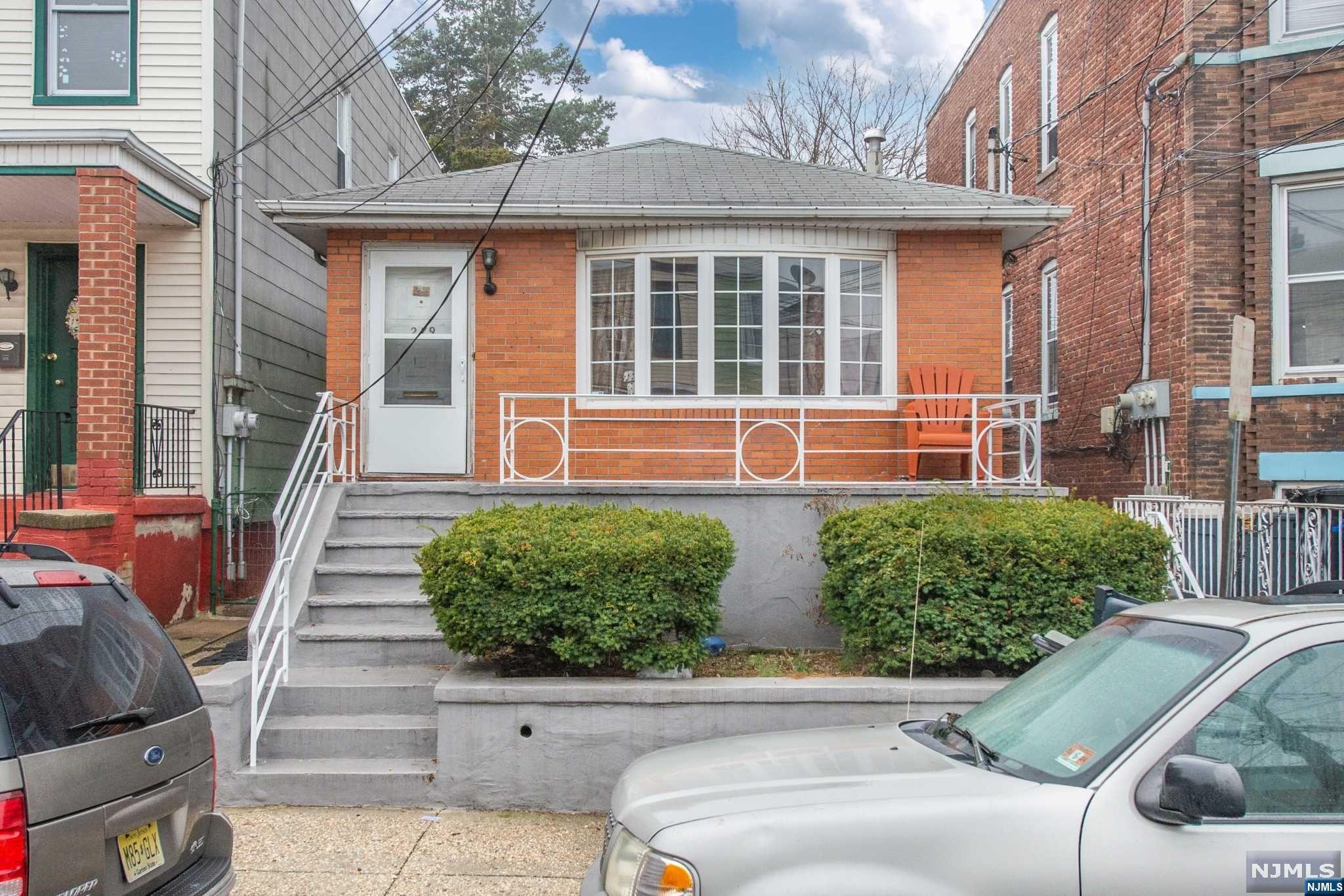 WELCOME HOME to this charming brick built ranch in the Greenville neighborhood of Jersey City. Perfect starter home for the first time home buyer, or as a rental property for the savvy investor. The main level of this two bedroom two bathroom ranch has a combination dining and living area with plenty of light streaming in from the large bay front windows that overlook the front porch. Kitchen has plenty of counter and cabinet space for all your kitchen appliances. The sunroom has windows on all sides - perfect for plants or well lit office space. Back door of the building can serve as a separate entrance for the in-law suite located in the fully finished basement which expands the length of the property. Fully functioning kitchenette with standing side by side fridge and freezer with additional dry pantry. A 15 MINUTE WALK to the Danforth Ave Light Rail Station and N.J. Transit Bus around the corner, THIS PROPERTY IS NOT TO BE MISSED. Being sold "AS IS" BRING ALL OFFERS.