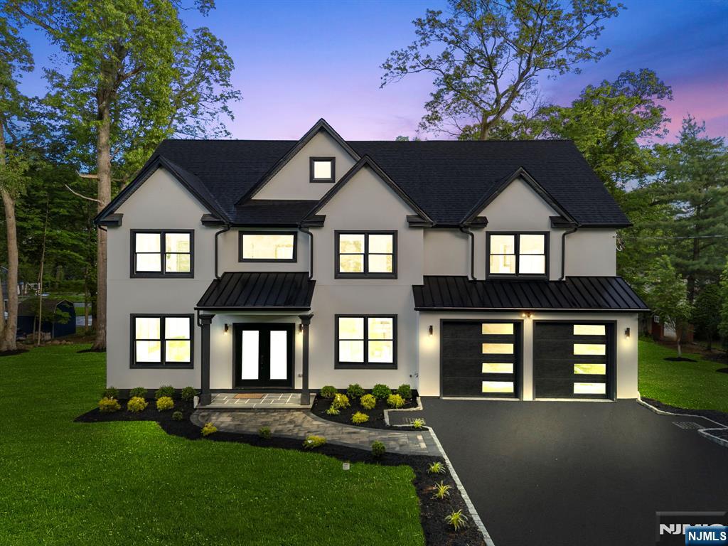 This modern new construction luxury home offers the perfect blend of sophistication, comfort, and cutting-edge features across three levels of thoughtfully designed living space. With 5 bedrooms and 5.5 bathrooms, the residence showcases sleek hardwood floors on all levels and refined custom woodwork, including striking coffered ceilings that add architectural depth and elegance throughout. Designed with modern living in mind, the home features in-law accommodations, a spacious loft, and a high-end electric fireplace that serves as a stylish focal point. The gourmet kitchen is equipped with Thermador WiFi-controllable appliances and a generous walk-in pantry, seamlessly combining high performance with upscale aesthetics. All lighting throughout the home offers five customizable color settings, ranging from 2700K to 6000K, allowing you to tailor the mood and ambiance in every room. The primary suite is a luxurious retreat, featuring his and her closets and a spa-like bathroom with a heated floor for added comfort. Additional highlights include Ring camera spotlights in both the front and rear for enhanced security, lush professionally designed landscaping, and an epoxy-coated garage floor. Ample bonus living space is available in the walk-up attic, and the property features Nicolock Stone Ridge XL granite city pavers with the option to expand the patio area. A two-car garage completes this exceptional home, where every detail reflects the highest standard of modern luxury.