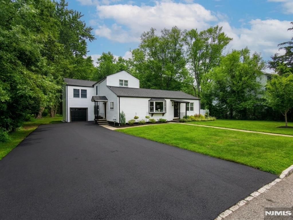 Welcome to this beautifully expanded ranch home in Fairfield, where timeless elegance and modern luxury come together on a private half-acre lot. This move-in ready 5 bedroom, 3 full bath residence showcases thoughtful design, recessed lighting, refined finishes and an open, inviting layout. The designer kitchen features quartz countertops, custom cabinetry, SS appliances, a breakfast bar, dedicated coffee station and seamless flow into the mudroom. The spacious living room is centered around a modern electric fireplace, creating the perfect space to relax or entertain. The first-floor primary suite serves as a private retreat with a custom walk-in closet and a spa-inspired en-suite bathroom featuring double vanities and luxurious finishes. Also on the first floor are a beautifully designed home office, first-floor laundry and an inviting sitting area overlooking the backyard. Upstairs, you'll find 3 generously sized bedrooms and a spacious family room, offering endless possibilities for a media room, playroom or home office. Step outside to your private backyard oasis featuring paver patios, an above-ground pool and plenty of space for entertaining family and friends. Additional highlights include a newly paved driveway, attached 1-car garage, new roof, central air, forced hot air and public water and sewer. Conveniently located near shopping, restaurants, top-rated schools, major highways and NYC transportation, this exceptional home is ready to welcome its next owners.