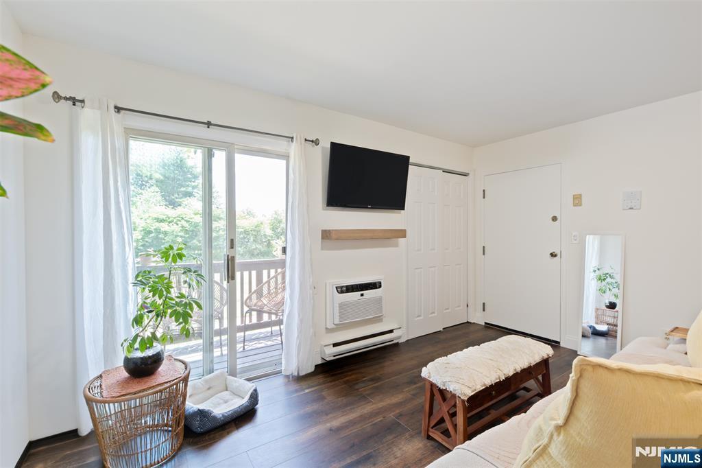 Welcome home to this beautifully updated first-floor 2-bedroom, 2 full-bath condo offering stylish finishes, spacious living areas, and peaceful surroundings in the heart of Pompton Lakes.Step inside to an inviting open-concept living and dining area featuring rich hardwood-style flooring, abundant natural light, and sliding glass doors leading to a private covered balcony overlooking open green space perfect for relaxing with your morning coffee or unwinding at the end of the day.The renovated kitchen is a standout, showcasing white shaker cabinetry, quartz countertops, subway tile backsplash, stainless steel appliances, and ample cabinet and counter space for everyday living and entertaining.The spacious primary suite offers a large walk-in closet and a beautifully updated en-suite bath with a double vanity. A generously sized second bedroom and renovated full guest bath provide comfortable accommodations for guests, or a home office.Additional highlights include first-floor convenience with no stairs to access the unit, in-unit laundry, updated flooring throughout, generous closet space, assigned parking, and a private covered balcony with tranquil views of the surrounding green space.Conveniently located near shopping, restaurants, parks, major highways, and NJ Transit, this move-in ready condo combines comfort, style, and everyday convenience.
