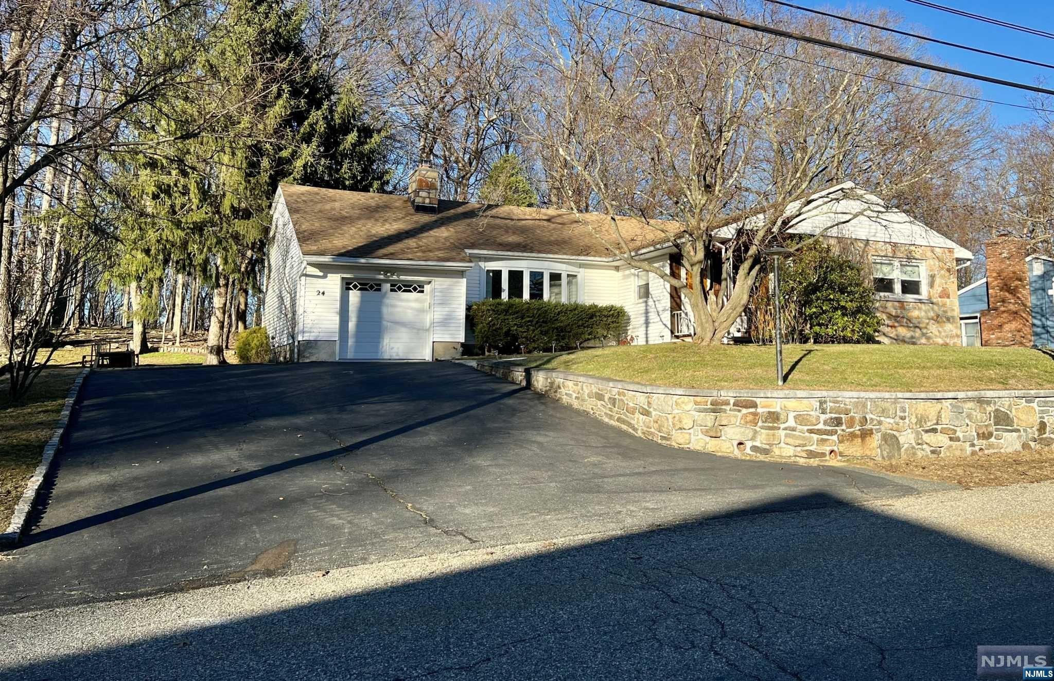 Gracious Expanded Ranch on elevated .23 acreage within minutes of LK Hopatcong. Open lot backs state property. No Flood. 8 Spacious rooms which includes 4 bedrooms, Formal DR, Formal LR, Large EIK. 1 car garage with interior access and extra-large basement that is half finished. The other half includes laundry, utilities and a workbench area as well as interior & exterior access. The 4th bedroom is set apart so perfect for someone who needs a little privacy or nanny situation. Fireplace in LR and freestanding wood stove in basement. Septic has just been professionally refurbished & approved by town.