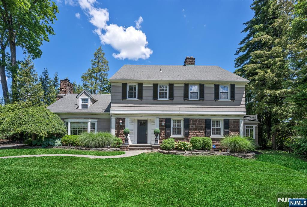 Nestled in Ridgewoodâ€™s coveted Old Country Club section, this stately Center Hall Colonial blends timeless charm with beautifully updated living spaces. Classic architectural details, elegant moldings, and thoughtful design are showcased throughout the home. A gracious foyer welcomes you inside, where the formal living room features a beautiful bay window and fireplace and flows seamlessly into the open-concept dining room and stunning updated kitchen. Complete with a large center island, high-end stainless steel appliances, abundant storage, and a butlerâ€™s pantry with refrigerator drawers and wine fridge, this space is ideal for everyday living and effortless entertaining. A spacious family room with a breathtaking stone fireplace creates the perfect gathering place, while a sun-filled den with walls of windows and French doors opens to the patio. A mudroom with built-ins and a powder room complete the main level. Upstairs, the primary suite offers a walk-in closet and ensuite bath, joined by an additional ensuite bedroom, two bedrooms connected by a full bath, and a dedicated office or nursery with access to the walk-up third floor, offering excellent potential for additional finished living space. The finished lower level includes a recreation room, laundry area, and powder room. Outside, enjoy a private backyard with a paver patio and a detached 3 car garage with loft space above. A truly special offering in one of Ridgewoodâ€™s most desirable neighborhoods!