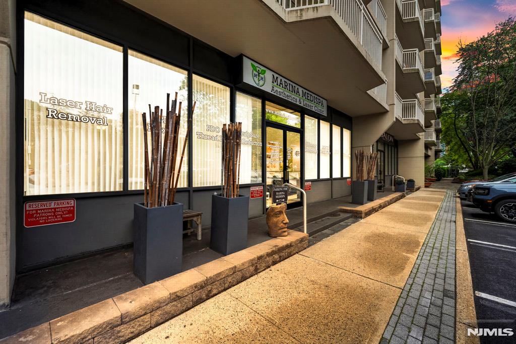 RARE OPPORTUNITY TO OWN A TURNKEY COMMERCIAL CONDO IN PRIME EDGEWATER! Ideally located directly on River Road with excellent visibility and positioned within a 300-unit residential complex, this beautifully renovated space is perfectly suited for a medspa, aesthetics practice, doctorâ€™s office, wellness center,beauty concept or similar end-user. Currently operating as a premier aesthetics medispa, the property was completely renovated in 2018 and designed for immediate professional use. The layout features a welcoming reception area, 5 private treatment rooms with hot & cold water in each room, bathroom, kitchen, impressive 12FT ceilings, approx. 1,100sqft plus a 204sqft private porch, and 5 parking spaces including 4 visitor spots directly in front & 1 deeded covered space. Direct neighbors w plastic surgeon, dentist and hair salon, creating strong business synergy for medical, beauty, welness and aesthetic-related uses. Certified for small surgeries. A true turnkey opportunity with equipment, website and client database included in the sale. Ownership also includes access to resort-style amenities including pool, gym, tennis court,event room, 24hr concierge&security. Unbeatable Edgewater location near luxury residences, shopping, dining, NYC transportation at your doorstep via bus or ferry. Perfect for the end-user looking to own instead of lease and step into a highly improved, ready-to-operate space in one of Bergen Countyâ€™s most desirable commercial/residential corrid