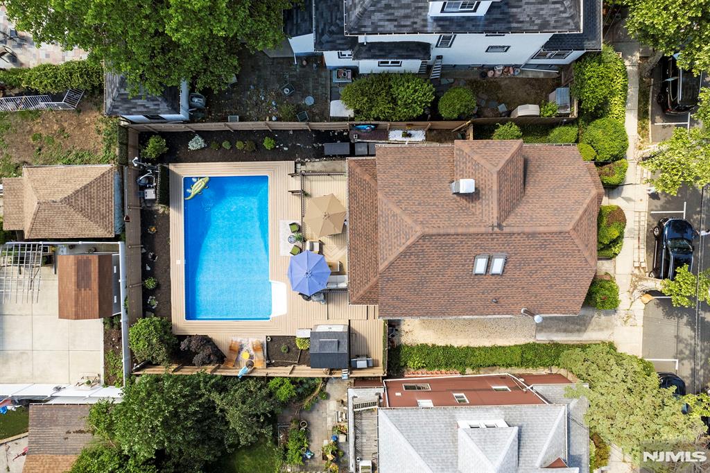 An exceptional North Bergen find: a beautiful 4-bedroom, 3.5-bath single-family home set on an extra-large 50 x 100 lot with a show-stopping outdoor retreat, complete with a large heated in-ground pool surrounded by Trex decking. Just one block from James J. Braddock Park, this classic Colonial-style home offers a truly unmatched NYC metro lifestyle: pickleball at 11, poolside by 12, and Midtown approximately 30 minutes door-to-door via public transportation. Inside, timeless character meets modern function with stained glass windows, inlaid hardwood floors, pocket doors, rich wood details, a classic staircase, and a renovated kitchen. Flexible living space across multiple levels includes a finished attic ideal for a bedroom, office, lounge, playroom, or guest retreat, plus a lower level offering additional versatility with another room, full bath, laundry and storage. The backyard is the headline. Morning coffee on the deck, afternoons by the pool, outdoor dinners, and weekends without the shore traffic create a private summer-at-home escape rarely found in Hudson County. Additional highlights include driveway parking for multiple cars, 3.5 baths, and cafÃ©s, restaurants, shops all walkable for true city living. 167 acre Braddock Park and NYC transportation are both just 1 block. For buyers moving up from a condo or searching for space, parking, character, outdoor living, and city access, this is the one to see. Skip the shore traffic. Summer is in your backyard.