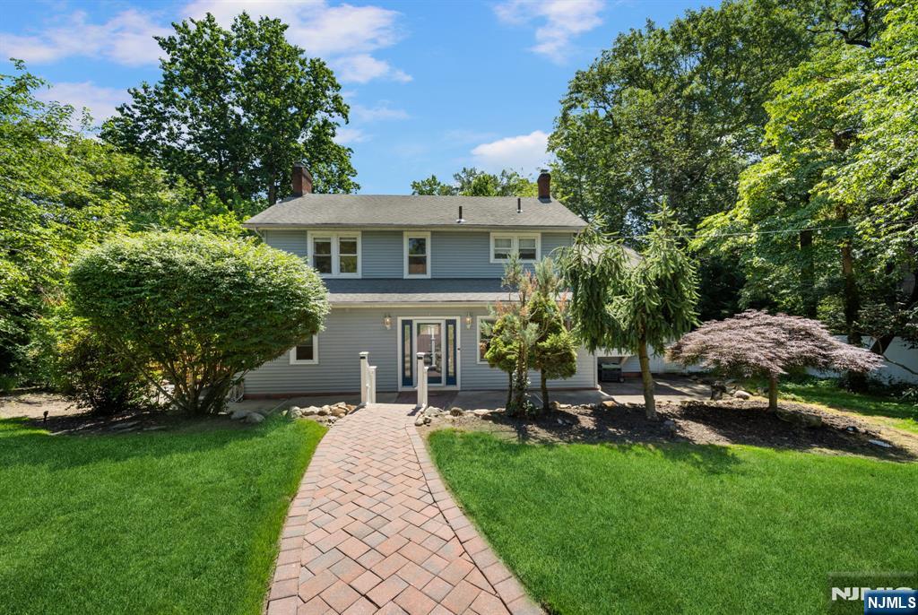 A Truly Special Home in the Heart of Bergen County. Welcome to 392 Lafayette Avenue, a charming five-bedroom, three-bath Center Hall Colonial nestled on over an acre of wooded privacy in one of Westwoodâ€™s most sought-after neighborhoods. This move-in-ready home blends timeless charm with modern upgrades, including a fully renovated farmhouse-style kitchen with quartz counters and custom cabinetry. The open layout flows seamlessly from kitchen to dining and family rooms, perfect for entertaining. Relax in the formal living room with a cozy wood-burning fireplace or unwind on the serene lemonade porch overlooking lush forest. Upstairs, the spacious primary suite and three additional bedrooms plus bonus Flex room, offer comfort and plenty of natural light. The finished lower level adds two bedrooms, a bath, and walk-out access. Step outside to a beautifully landscaped, fenced backyard with an above-ground pool warmed naturally by the sun. A detached oversized two-car garage features a spacious unfinished loftâ€”ideal for storage, a hobby room, or a lively hangout space. Located near top schools, NYC transit, and vibrant downtown, this home offers the perfect blend of privacy, luxury, and lifestyle. Experience the best of Westwood living at 392 Lafayette Avenue.
