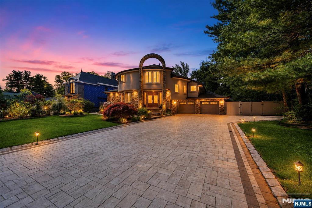 Tucked away on a private lot in one of Paramusâ€™s most sought-after neighborhoods, this beautifully renovated contemporary offers approximately 6,731 square feet of exceptional living space with 6 bedrooms and 5½ bathrooms. A striking brick and stone facade, long private driveway, and attached 2-car garage create an impressive arrival. Designed for both grand entertaining and comfortable everyday living, the light-filled interior features an elegant entry foyer, living room, formal dining room, powder room, spacious eat-in chefâ€™s kitchen, family room with fireplace, library, den/home office, and a first-floor bedroom suite with a full bath. The second level is highlighted by a luxurious primary suite with a spa-inspired bath, three additional bedroom suites with full baths, and an additional bedroom, offering remarkable flexibility for family and guests. A fully finished basement provides abundant recreation and bonus living space. Outside, a private backyard oasis awaits with a heated in-ground pool, expansive entertaining areas, and beautifully landscaped grounds that create a true resort-like setting. Combining generous living space and an exceptional Paramus location, this outstanding residence offers luxury living at its finest.