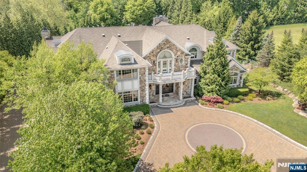 Once in a lifetime opportunity to own one of North Caldwell's most iconic estates. 11 Rickland Drive is a custom home built in 2009 with over 11,000 square feet across 30 thoughtfully designed rooms. Grand yet inviting, itâ€™s ideal for large-scale entertaining or intimate living. There are seven bedrooms, each with a private ensuite, plus nine full and two half baths. Highlights include a dual staircase, soaring ceilings, arched passageways, rich millwork, designer finishes, multiple balconies and an elevator to all levels. The main floor offers a gourmet kitchen with breakfast room and island, formal living and dining rooms, vaulted sunroom, office with fireplace, cabana room with bath and wood-burning fireplace, and a theater. Upstairs, the primary suite features a sitting room, den with kitchenette, balcony and spa-like bath. The lower level includes a dance floor, gym, spa, arcade and guest suite. Outside, 2.37 acres offer a pool, slide, waterfall, bar and firepit.