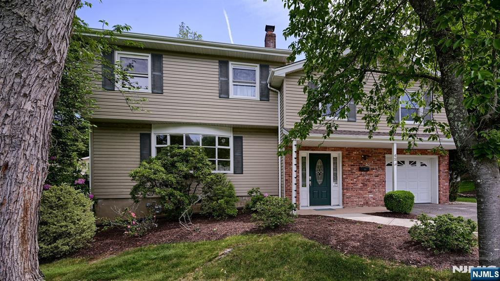Welcome to 42 Stirling Lane, a spacious and well-maintained 5 Bedroom Split Level set on a private corner property in a desirable neighborhood! An inviting foyer with two closets welcomes you into this warm and functional home. The ground level offers a versatile Den currently used as a Mudroom, Powder Room with Laundry and access to the attached 1 Car Garage. The sun-filled main living area features a spacious Living Room with oversized bay window, formal Dining Room and an updated Eat-in Kitchen complete with granite countertops, stainless steel appliances and ample cabinetry. Upstairs offers 5 Bedrooms including a Primary Suite with full Bath and walk-in closet, plus an additional main Bath. The partially finished Basement expands the living space with a Rec Room ideal for entertaining, gym, playroom or home office, along with storage and utility rooms. Step outside to enjoy the fenced private backyard with paver patio, spacious side yard and large front lawn perfect for outdoor entertaining, gardening or play. A custom shed provides additional storage. Conveniently located near top-rated schools, shopping, restaurants, Whole Foods Market, major highways and NJ Transit bus and train service. A fantastic opportunity to make this wonderful home your own!