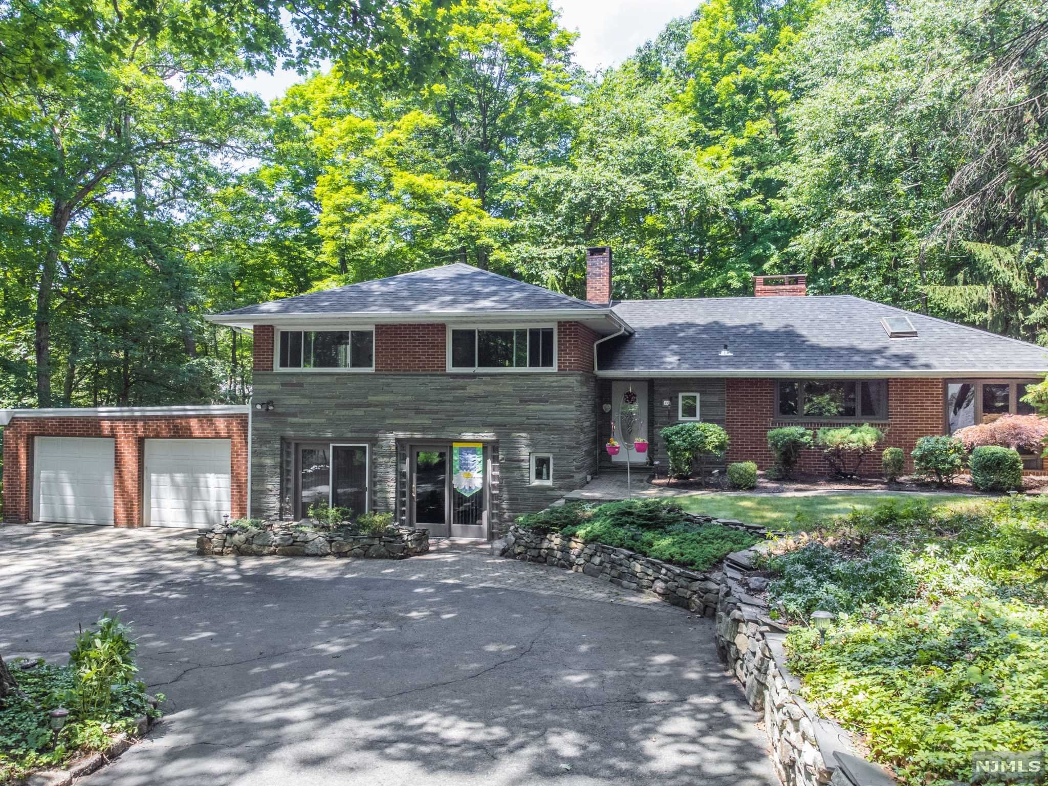 Perfectly nestled on a quiet cul-de-sac in the idyllic Smoke Rise Club, just a half mile to the private community beach access, this brick & stone split level home is awaiting its new owners with years of future joyful memories to be made. Newer 50 year roof (installed 2020), Central AC. Laminate plank flooring in family room. Beautiful setting - come make this home your own! Smoke Rise has a one time application fee & monthly HOA fees - call agent for more details if you're not familiar with this private gated community.