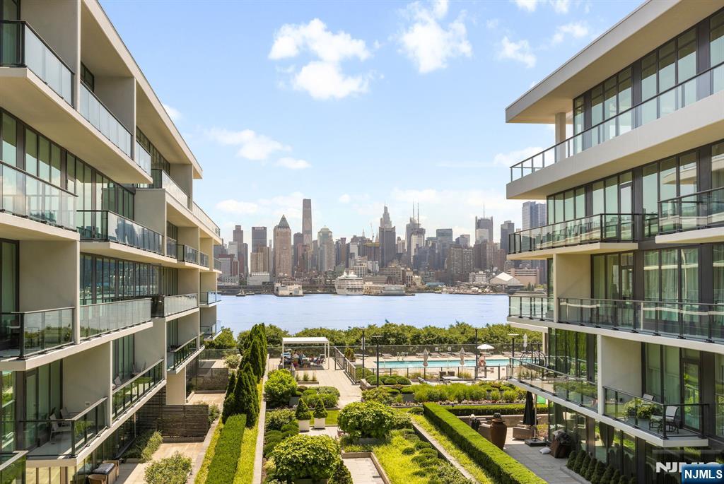 (Contact NELSON CHEN at 2 0 1 - 8 8 6 - 8 0 0 0) - THE AVENUE COLLECTION Building 1200 - Residence 513. Imagine waking up to the sun rising over Manhattan every day. With 1226-SF, this home's unique prime position within the building provides each room with direct views of the Hudson River and the midtown Manhattan skyline. Tall ceilings over 9-feet and walls of floor-to-ceiling windows provide amazing light. Extensive upgrades include stunning refinished wood floors, automated window blinds with full blackout shades in the bedrooms, custom built closets and designer LED light fixtures. Monogram appliances, fixtures by Kohler, waterfall counters and layers of lighting grace the kitchen and baths. A deeded parking space completes this rare offering in Port Imperial's finest building just 2 blocks from the ferry terminal. Come experience the boutique lifestyle of the Avenue Collection that includes 24-hour concierge service, health club, movie theatre, kid's playroom, penthouse level Skyline Lounge and the ultimate 3rd level resort style pool deck. Welcome Home - (Presented by THE CHEN AGENCY, 2 0 1 - 3 4 6 - 8 8 8 8, N e l s o n @ C h e n A g e n c y . c o m)