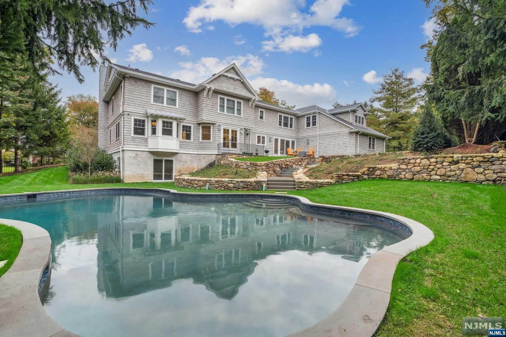 Welcome to this stunning thoughtfully renovated home with elegant & sophisticated touches throughout. The first floor boasts a spacious living rm, formal dining rm, and a family rm. The kitchen, w its center island, quartz countertops & classic white cabinetry, is a chef's dream, offering both functionality & style. For those who appreciate a quiet space to work or study, this home features a private study. The entire house has been hardwired, ensuring seamless connectivity. The 1st flr includes a guest ensuite bedroom, laundry rm & a convenient back-staircase. Second flr offers a thoughtfully designed layout that maximizes both comfort & functionality, w a secondary laundry rm & media rm. Primary bedrm is a true retreat & FOUR addl bedrooms grace the second flr. Picturesque & private setting on this ample 1.24-acre property w saltwater pool. This home truly offers the perfect balance btwn elegance & functionality, making it the ideal residence for those seeking luxury and comfort