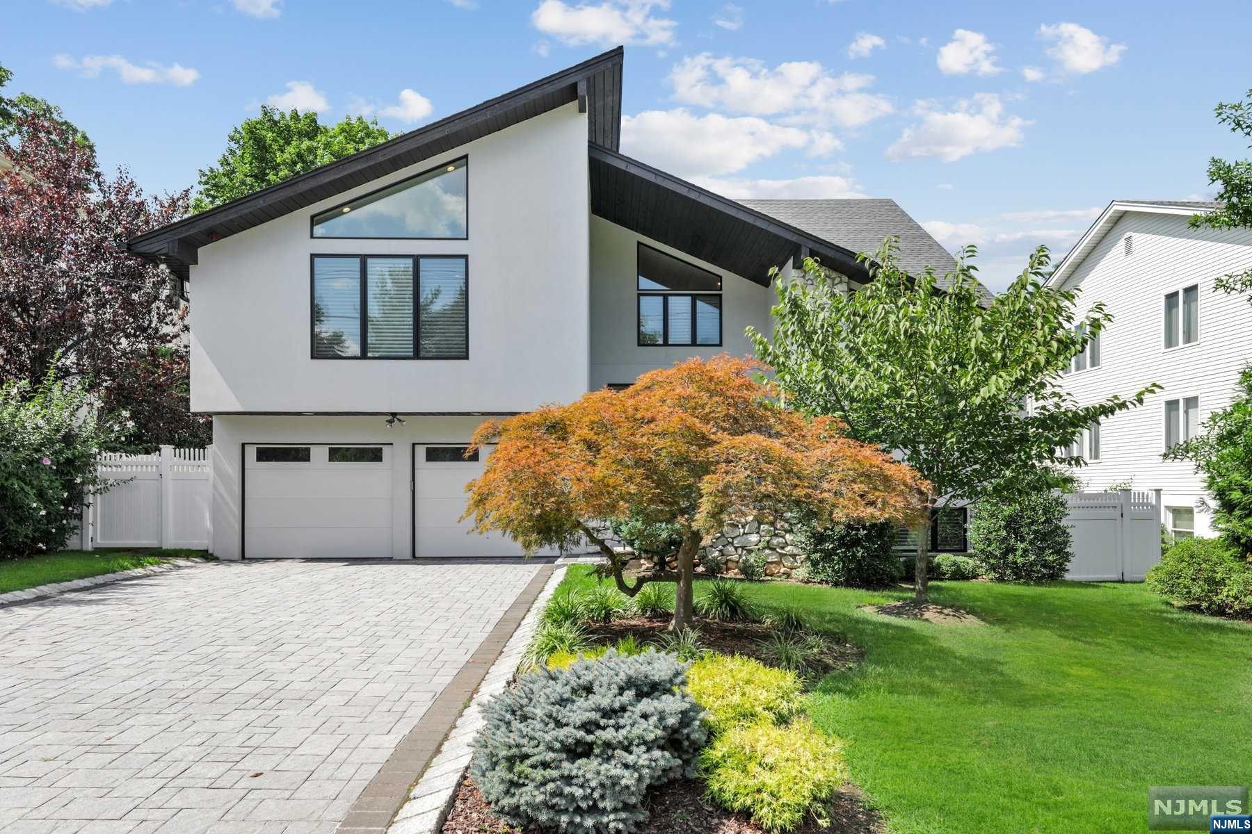 MOVE RIGHT IN to this fully renovated Contemporary Colonial located minutes from NYC in the low tax town of Englewood Cliffs. The modern design features an open floorplan with many high ceilings,large windows,a new kitchen and all new bathrooms. The Main level features a large Entrance Foyer with designer tile, Modern Kitchen open to a Great Room with vaulted ceiling and fireplace,Living Room,Dining Room and Powder Room. The Primary Suite boasts a large bedroom with vaulted ceiling,5 closets and a luxurious bathroom with double vanity,free standing tub,shower and radiant heat. The Lower level includes a Recreation room with several windows and an outside exit,a large Bedroom,1.5 Baths and an additional room. Additional upgrades include: new masonry stucco,paver driveway,Pella windows,roof,8 zone HW furnace,central A/C,electric,central vacuum, PVC fence and alarm. Low taxes and conveniently located close to public NYC transportation.