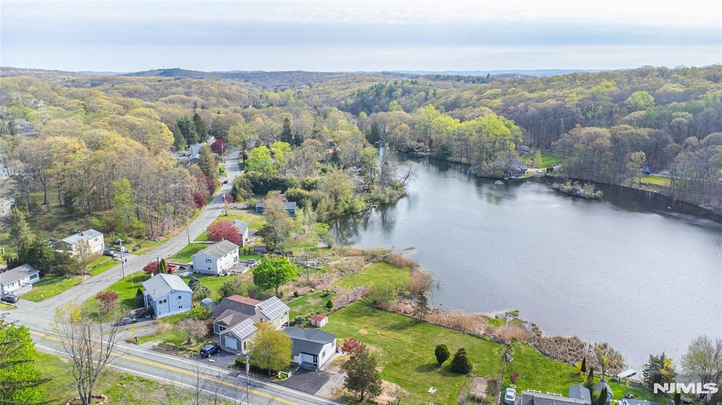 Welcome to this fully renovated lakefront gem in the desirable Mount Glen Lakes section of West Milford. Set on an oversized, level 0.40-acre lot with direct lake frontage and year-round water views, this 3-bedroom, 2-bath ranch offers the perfect blend of modern design and effortless one-level living. Completely redesigned in 2025, every detail has been thoughtfully updated for todayâ€™s lifestyle. Step inside to a bright, open living/dining area with beautiful wood floors and abundant natural light. Sliders off the living room lead to a deck overlooking the lake â€” the perfect place to relax or entertain while enjoying peaceful waterfront scenery in every season. The stunning new kitchen features sleek cabinetry, stylish countertops, and stainless steel appliances, including a gas range. One bedroom features its own private full bath, while two additional bedrooms share a second beautifully renovated bath. A convenient main-floor laundry closet is located in the hallway for easy access. The lower level offers excellent storage space and houses the utilities. With central air, natural gas heat, a blacktop driveway, lake privileges, and turnkey condition throughout, this is true one-level lake living at its finest.