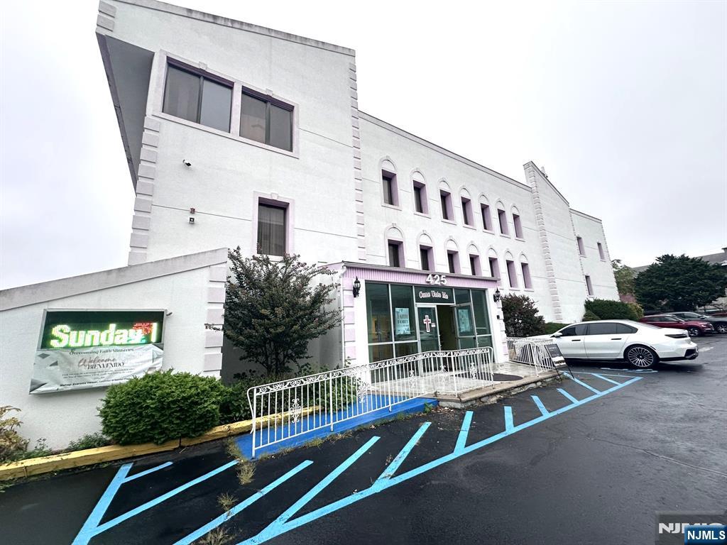Modern style building zoned for special purposes on over half an acre. Features 80 parking spaces in fenced in area. Separate office building included in sale. 32 pews accommodating 340. Raised platform for choir and parishioner. Baptismal pool and changing room. Multi levels with offices, kitchen, full sized dining area and passenger elevator. Loading dock