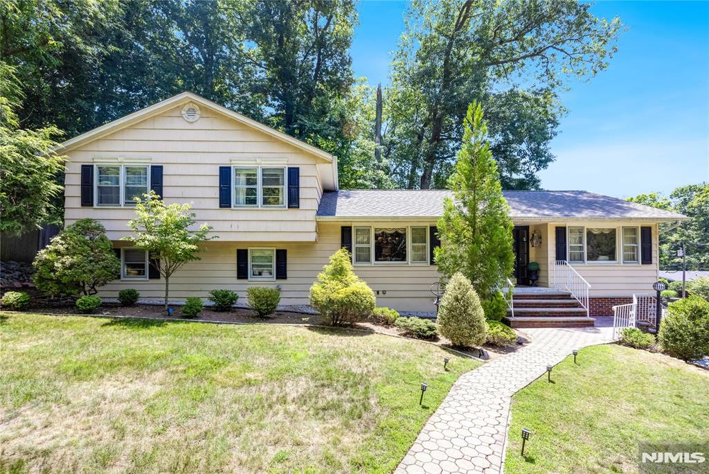 Opportunity knocks at this highly sought-after Oak Forest Section of Northern River Vale! This 4 BR, 2.5 Bth Split-Level home is ideally situated on a picturesque, tree-lined corner lot & offers a welcoming floor plan & expansion potential. The main level features a spacious entry foyer leading into an oversize Living room, flowing seamlessly into the formal Dining room & a Eat-in Kitchen with SS appliances & direct access to a backyard. The upper level features a spacious Primary Bedroom, 2 closets & a full bath, along with 2 additional generously sized bedrooms & a updated full bath. Hardwood floors run throughout the main & upper level. The lower level features a 4th Bedroom, a powder room, & a separate Laundry room. Additionally there is a Family room w sliding glass door to a patio/backyard with lush greenery in a private setting. A partially unfinished basement provides wonderful storage, houses the utilities with access to a 2-car garage & sprawling driveway; Central AC. Bring your vision & creativity. Conveniently located close to top-rated schools, local amenities, parks & transportation.