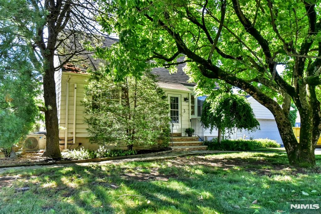 Move right in to this charming, cozy home in the desirable town of Westwood! The first floor features a mudroom that leads to a very spacious living room with sliding glass doors to the back yard. The updated kitchen has beautiful wood floors and opens to a nice size dining room. The first floor also includes a full bath. The second level is warm and inviting with 2 good size bedrooms and ample closet space. Wood floors throughout the entire 1st and 2nd floor, a finished basement with new floors, a large laundry room and a 2 car garage complete this lovely home. Mature, picturesque trees surround the fenced in yard with a patio. Close to NYC transportation and downtown Westwood.