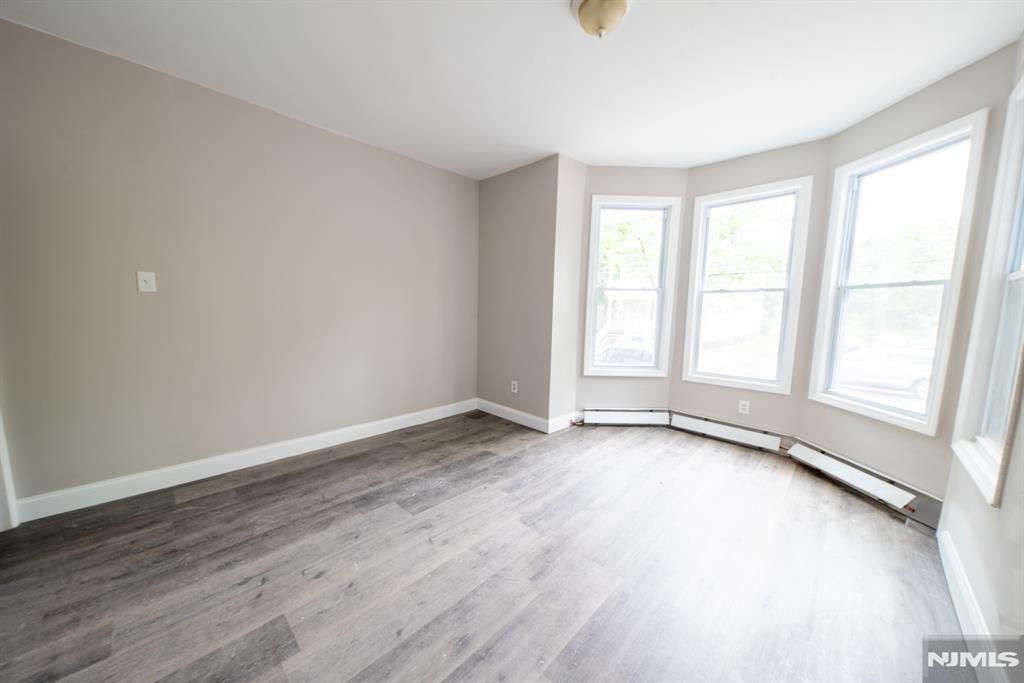 Renovated 3-bedroom, 1-bath apartment offering a spacious and functional layout. This bright and inviting home features a large living room, separate dining room, and new flooring throughout. Abundant natural light fills the space, creating a warm and comfortable atmosphere. Enjoy access to the backyard, on-site laundry facilities, and a convenient location near major highways, shopping, dining, and public transportation to NYC.