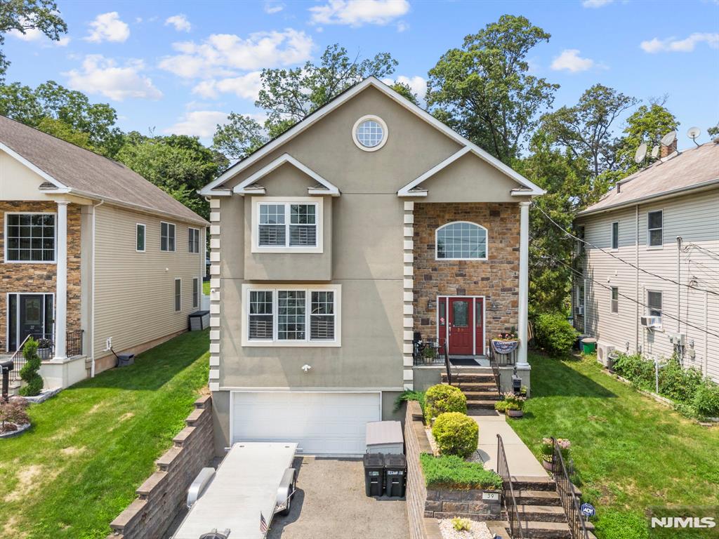 Welcome to this exceptional custom-built Colonial in Clifton's highly desirable Allwood section, offering over 3,200 square feet of beautifully appointed living space on a rare 0.49-acre lot. Built in 2016, this impressive home features 4 spacious bedrooms, 2 full baths, 1 half bath, and an open floor plan designed for both everyday living and entertaining. The inviting 30-foot grand foyer creates a stunning first impression and leads to a formal living room, elegant dining room, and spacious family room. The gourmet eat-in kitchen offers granite countertops, custom cabinetry, stainless steel appliances, a center island, and sliding doors opening to a paver patio overlooking the private backyard. Upstairs, the luxurious primary suite features a walk-in closet and spa-inspired bath with a soaking tub, oversized shower, and dual vanity. Three additional bedrooms, a full bath, and second-floor laundry complete the upper level. The finished basement offers a large recreation room. Additional highlights include hardwood floors, recessed lighting, central air, solar panels, a two-car attached garage, and a maintenance-free exterior of stucco, stone veneer, and vinyl siding. Enjoy the heated above-ground pool, mature landscaping, and exceptional outdoor space. Conveniently located near parks, shopping, major highways, and NYC transportation, this property offers the perfect blend of luxury, space, comfort, and modern living in one of Clifton's most sought-after neighborhoods.