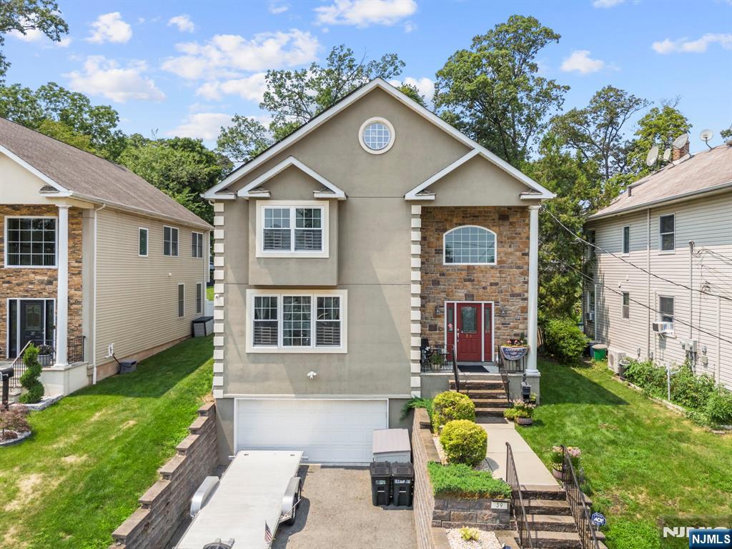 Welcome to this exceptional custom-built Colonial in Clifton's highly desirable Allwood section, offering over 3,200 square feet of beautifully appointed living space on a rare 0.49-acre lot. Built in 2016, this impressive home features 4 spacious bedrooms, 2 full baths, 1 half bath, and an open floor plan designed for both everyday living and entertaining. The inviting 30-foot grand foyer creates a stunning first impression and leads to a formal living room, elegant dining room, and spacious family room. The gourmet eat-in kitchen offers granite countertops, custom cabinetry, stainless steel appliances, a center island, and sliding doors opening to a paver patio overlooking the private backyard. Upstairs, the luxurious primary suite features a walk-in closet and spa-inspired bath with a soaking tub, oversized shower, and dual vanity. Three additional bedrooms, a full bath, and second-floor laundry complete the upper level. The finished basement offers a large recreation room. Additional highlights include hardwood floors, recessed lighting, central air, solar panels, a two-car attached garage, and a maintenance-free exterior of stucco, stone veneer, and vinyl siding. Enjoy the heated above-ground pool, mature landscaping, and exceptional outdoor space. Conveniently located near parks, shopping, major highways, and NYC transportation, this property offers the perfect blend of luxury, space, comfort, and modern living in one of Clifton's most sought-after neighborhoods.