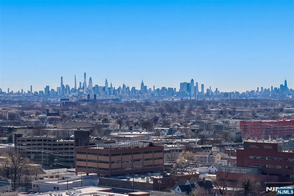 This is it! Stunning unobstructed NYC and panoramic views are yours from the private terrace and all rooms of this luxury home. Enjoy spectacular sunrise and evening skyline views. Located in the tallest (25 stories) and very desirable Devonshire in the heart of the prestigious Prospect Avenue high rise area. And, brightest southeast corner exposure with loads of windows/sun filled living space. Appx 1464 sf includes spacious EIK with NEW appliances. Large separate dining room ideal for entertaining. Separate side king size 18' bedrooms & room size entry foyer. Updated flooring. 2 garage parking spaces available. General storage included. Plus a large lockable storage bin available for an add'l $75/mo. 24 hour doorman, pool, state of the art exercise gym. All utilities included in the monthly fee. Ideally located steps from NYC EXPRESS bus; near NYC train, local buses and very close to HUMC medical center. Easy NYC access by car. Near all malls, shops and major highways.