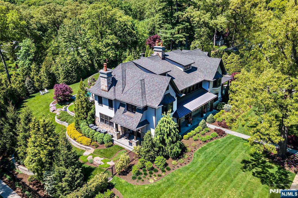 Experience luxury at its finest in Ridgewood's coveted Heights with this stunning 2019 custom-built estate that sets the benchmark for upscale living. Every aspect of this intricately designed residence was thought out at the highest level of detail and design, showcasing exquisite craftsmanship seamlessly integrated with cutting-edge smart home technology. The list of features is extensive. Gourmet kitchen with best-in-class appliances/3 refrigerators/oversized center island/butler pantry. Grand living room connects seamlessly to the outdoor space through sliding glass doors, while a lavish lounge offers a bar fit for grand scale entertainment. Primary suite impresses with a balcony, spa-like bath and stunning ceiling details. Two home offices, 3,600SF finished basement with state-of-the-art gym, 3-car garage. Experience utmost privacy with architecturally landscaped grounds, gunite pool, covered outdoor patio with fireplace and dining area. The oasis you've been dreaming of!