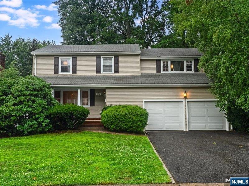 Located on a desirable street in the heart of Paramus, this lovely Colonial offers 4 bedrooms and 3.5 baths in a prime location close to everything. The first floor features a spacious living room, a formal dining room currently used as a library, a beautifully updated kitchen with quartz countertops and stainless steel appliances, and a welcoming family room with a fireplace, currently used as a dining room, with sliding doors leading to a private backyard complete with a deck perfect for relaxing or entertaining. The second floor features a spacious primary suite with a full bath and a large closet, along with three additional generously sized bedrooms and a full hall bath. The finished basement offers exceptional additional living space with two versatile rooms, a full bath and a large play area, perfect for a home office, guest space, or recreation. Enjoy all that Paramus has to offer, including close proximity to Petruska Park, NYC transportation, houses of worship, shopping, dining, major highways, low taxes and excellent schools.