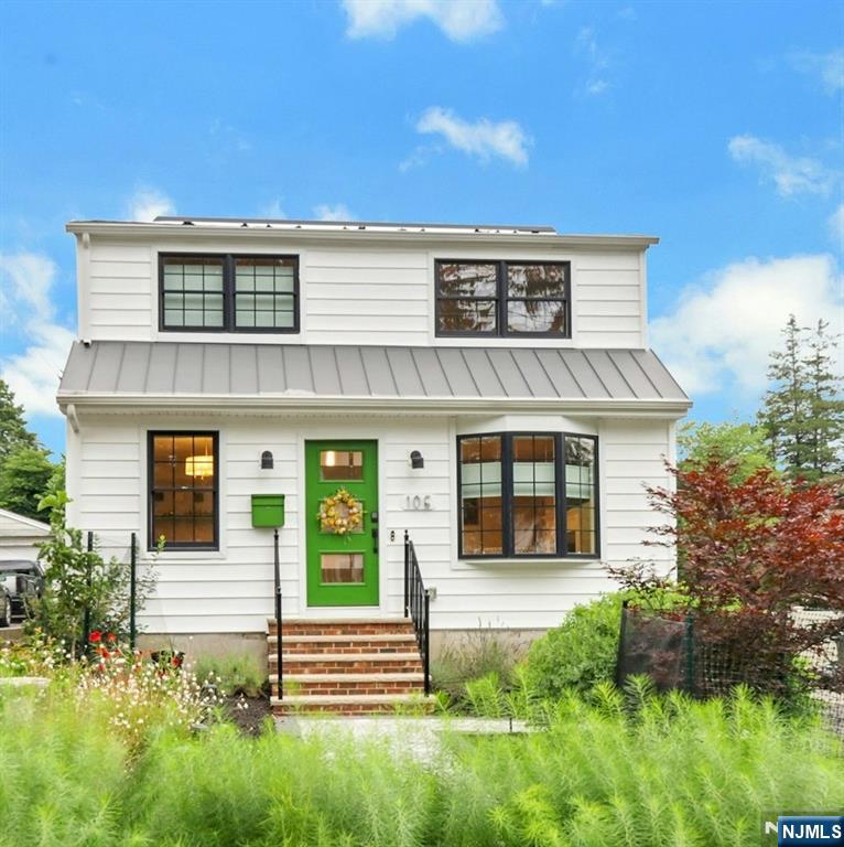 Welcome to your dream home in the heart of Westwood! Perfectly positioned near the vibrant downtown and the NYC train line, this fully reimagined property offers the best of both worlds: modern luxury and incredible convenience. Extensively rebuilt in 2022 with a spacious second-floor addition, this home feels brand new. Youâ€™ll love the natural hickory hardwood floors, cozy gas fireplace, and all the thoughtful custom built-ins, like the dry bar in the dining area and the handy entryway bench. The kitchen is an absolute showstopper. Whether youâ€™re a pro or just love to host, youâ€™ll appreciate the massive island, quartz countertops, and high-end stainless appliances, including a 48-inch dual-fuel Wolf range. Upstairs, the new primary suite is a true retreat with its own walk-in closet and private ensuite. With 4â€“5 bedrooms, a dedicated second-floor laundry, and a partially finished basement, there is plenty of room to spread out. Plus, the home is packed with upgrades for peace of mind, including all-new electrical, plumbing, a tankless water heater, and a water filtration system. Living here is easy and sustainable, tooâ€”the home comes with owned solar panels, a whole-home battery backup, and a Level 2 EV charger. Outside, enjoy the beautiful new stone patio and fresh landscaping. This place is move-in ready and waiting for its next chapterâ€”could it be yours?
