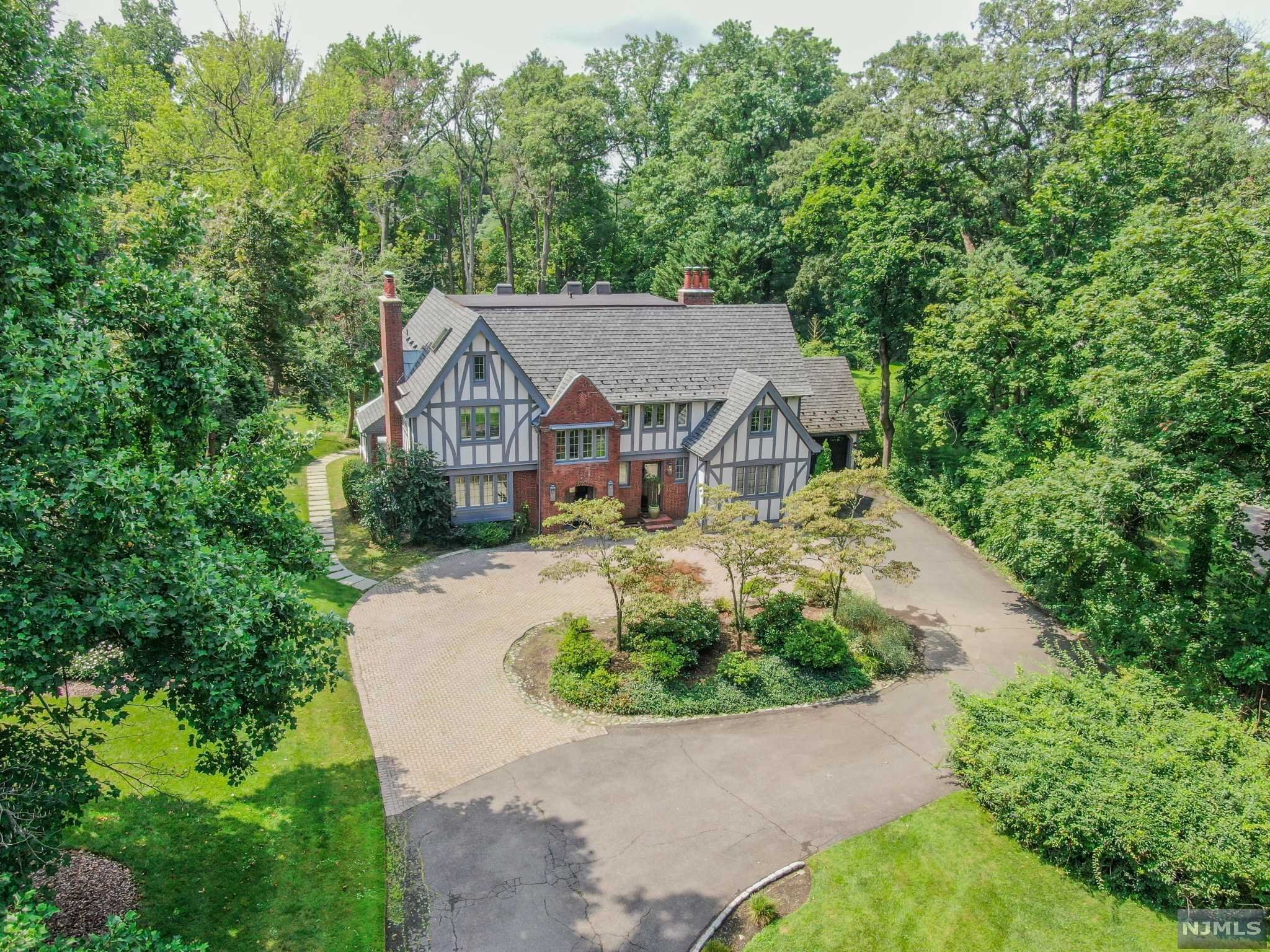 Welcome to 226 Chestnut Street... This magnificent home sits on approximately one acre of flat, park-like property within close proximity to houses of worship in the sought after East Hill of Englewood, NJ. Suburban living at its best and located only minutes from Manhattan, this 5 bedroom, 4 full and 1 half bath home has it all! Enter through the grand foyer straight into an elegant formal living room with fireplace. The massive eat-in chef's kitchen is equipped with two refrigerators, two dishwashers, 2 sinks and ample counter space. The main floor also features an oversized dining room, butler's pantry, den/family room, light filled office/sunroom and 2 car attached garage. Upstairs you will find the luxurious primary suite with a spa-like bathroom and walk in closet. 3 bedrooms and 2 additional bathrooms complete this floor. The third floor features an oversized bonus room/playroom, bedroom & full bath.