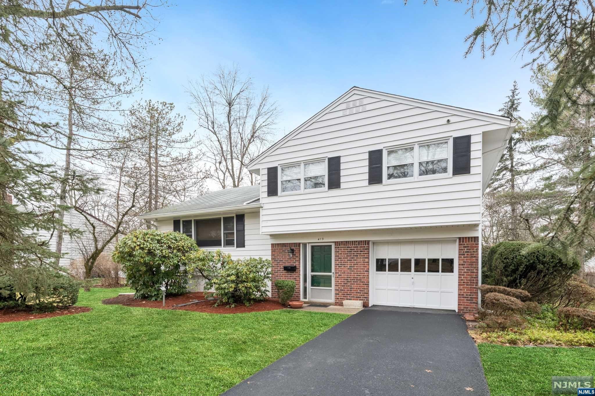 Welcome Home! This large, bright Sugar Maple Split in the desirable town of Cresskill boasts 3 bedrooms and 1.5 baths on a large level 100 x 101 lot. The ground floor welcomes you into the large entry foyer with closet, entrance to the garage, a family room with sliding glass doors to the outdoor patio, and a large half bath with laundry. The first floor features a large living room with built in cabinets for plenty of storage, large dining room, and a modern eat-in kitchen. The second floor has 3 bedrooms, and a full bath with a hall entrance and a separate primary BR entrance. The basement is full and unfinished. This lovingly maintained home includes hardwood floors, new hot water heater, electric deicing cables on roof and french drains in the basement. Don't miss your opportunity to own this well-maintained home, within walking distance to highly rated schools and public transportation, and live in one of the most desirable towns in Bergen County.