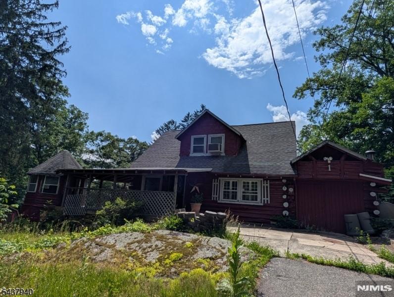 This unique log home is located in lower West Milford with convenient commute to all schools and major highways. The house features 3 bedrooms, one bath, large living room with stone fireplace, nice size kitchen with formal dining room and is easy walk to the community in ground pool. New septic will be installed prior to close and the home features newer boiler, hot water heater and water conditioning systems. Large covered front porch with enclosed log gazebo provide additional entertaining/multi use spaces.