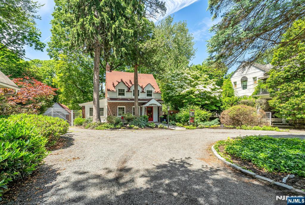 Looking for a historic single-family home in Teaneck, NJ with a private cul-de-sac lot, detached garage, and turnkey condition? This is it. 740 River Road is a 3-bedroom, 1.5-bath Dutch Colonial cottage designed in 1924 by Cornell-educated architect Frederick T. Warner â€” one of the most significant builders in Teaneck history â€” and expanded and renovated circa 2008. The home sits on an 8,451 sq ft private lot on a cul-de-sac shared by just three homes, with the seller holding ownership of the shared driveway. First floor: pine floors, wood-burning stone fireplace, decorative arched doorways, separate dining room, gourmet kitchen with six-burner Wolf range, KitchenAid professional exhaust, granite counters, custom white cabinetry, exposed brick backsplash, center island, and Spanish ceramic tile floor. Slider doors open to a wrap-around slate patio. Second floor: primary suite with bamboo floors, cathedral ceilings, a walk-in closet, and a picture window overlooking a fully fenced private backyard. Pass-through full bath with double-sink vanity and glass shower enclosure. Two additional bedrooms with hardwood floors. Semi-finished basement. Walk-up attic. Detached brick garage. Above-ground pool with a separate fence. 200-amp panel, new PVC sewer line, updated central air (multi-zone), smart lighting throughout. 23 documented improvements 2022-2026. Located at Cedar Lane and River Road, Teaneck, NJ 07666, Bergen County.