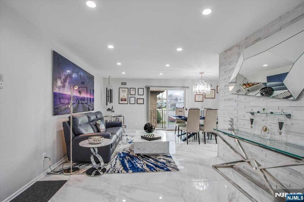 Beautifully renovated from the ground up, this fully furnished condo offers the perfect blend of modern luxury and comfort. Every detail has been thoughtfully updated, featuring brand-new appliances, high-end furnishings, elegant marble and ceramic flooring, and an open-concept layout designed for today's lifestyle. The spacious dining area is highlighted by a stunning crystal chandelier and flows seamlessly into the contemporary kitchen, complete with quartz counter-tops, shaker-style cabinetry, and top-of-the-line stainless steel appliances, including a gas range, refrigerator, and microwave. A conveniently located laundry room is tucked just behind the kitchen. The luxurious primary bathroom features heated floors and an over-sized walk-in shower, creating a spa-like retreat. Two generously sized bedrooms offer ample closet space and additional storage, providing both comfort and functionality. Step outside to your private balcony, the perfect place to relax and enjoy peaceful views overlooking the county park. With its exceptional renovations, stylish finishes, and move-in-ready furnishings, this condo is a rare opportunity to enjoy turnkey living at its finest.