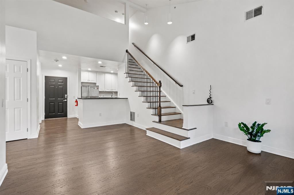 Welcome home to this top floor 3 bed 3 bath duplex premier waterfront building located at Hudson Pointe. This duplex home stretches across approx. 1383 sqft. The gourmet kitchen includes beautiful cabinetry, stainless steel appliances & granite countertops which overlooks the living room featuring a balcony. The master suite has an expansive walk-in closet & modern master bath. The second bedroom is very spacious with big windows, the top floor has a 3rd room that allows for flexible living options where it can be used as an office or a 3rd bedroom. The amenities include a 24hr doorman, fitness center, business center, cinema room & a pool. Enjoy the convenience of two car indoor parking(1 assigned & 1 floating) which is very rare! Easy access to NYC with NJ Transit, you don't want to miss this one!