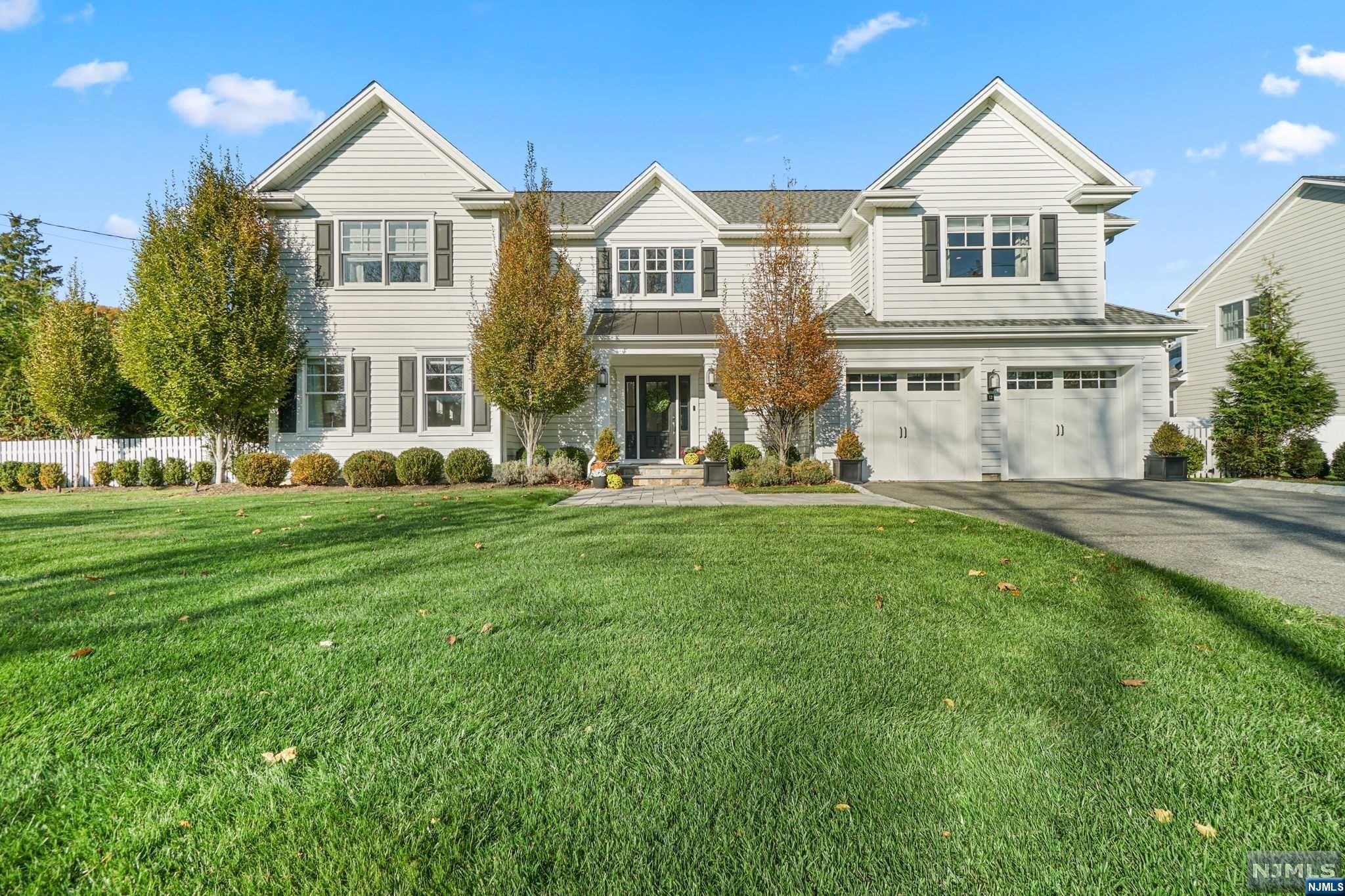 In a tranquil colonial haven, refinement meets opulence, embodying the Architectural Digest dream. Meticulously crafted with premium finishes, the exterior blends colonial charm with modern allure. A designer kitchen unfolds, boasting a new island, marble countertops, and top-tier appliances. The great room captivates with a 10' coffered ceiling and fireplace, complemented by hardwood and ceramic flooring. The master suite, a sanctuary, features a tray ceiling and a luxurious bath. Additional suites, a Jack and Jill bathroom, and a two-car garage complete this masterpiece. The backyard steals the spotlight a Hamptons-style pool, saltwater heated, adorned with custom granite in a sunken hot tub.