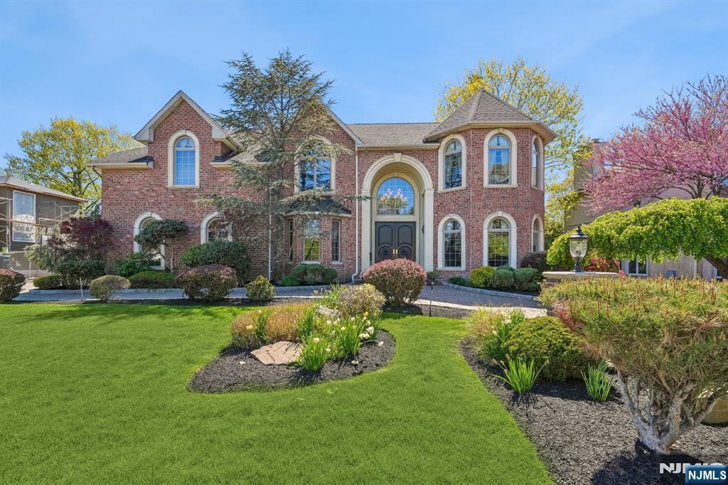 Welcome to this elegant custom-built brick home in the highly sought-after Roberts Road area of Englewood Cliffs. Built in 2003 and thoughtfully designed throughout, this 5-bedroom, 5.5-bath residence offers generous living spaces, upscale details, and a warm, inviting feel. A dramatic two-story entry foyer with a sweeping staircase sets the tone, opening to a handsome home office and gracious formal spaces. The heart of the home features a high-end chefâ€™s kitchen, perfect for gathering, and a stunning two-story great room with huge windows and an onyx wood-burning fireplace. All bedrooms feature private bathrooms, including the luxurious primary suite with a sitting area, spa-like bath with soaking tub and steam shower, and huge customized closets. The beautifully finished lower level offers even more living space with a theater room, recreation room, second kitchen, bedroom, full bath, sauna, and direct access to the backyard. Outside, enjoy a private setting with a heated pool, built-in grill, and patio area, ideal for relaxing or hosting. Additional highlights include radiant heat, a backup generator, circular paver driveway, and 3-car attached heated garage. Spacious, elegant, and located in one of Englewood Cliffsâ€™ most desirable neighborhoods, this special home is a wonderful opportunity for todayâ€™s luxury buyer.