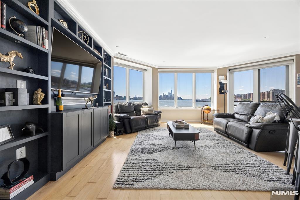 Experience exceptional waterfront living in this sun-drenched 2-bedroom, 2-bath condo, ideally positioned at the very end of the pier for maximum privacy and panoramic Hudson River and NYC skyline views. With southern exposure, enjoy direct, unobstructed views of Hudson Yards and Downtown Manhattan from nearly every room. Enter through your private elevator and dedicated front entry, creating a seamless, townhouse-like experience. The home features a spacious layout with a wood-burning fireplace, designer kitchen, and a private balcony overlooking the water. The primary suite offers a walk-in closet, soaking tub, and glass-enclosed shower. Additional highlights include an in-unit washer/dryer and refined finishes throughout. Residents enjoy 24/7 concierge and security, fitness center, pool, private pier access, deeded covered parking, and additional storage. Located just steps from the NY Waterway ferry (a 30-second walk), enjoy a quick 5â€“6 minute commute to Manhattan. Whole Foods and top waterfront dining, including Ruthâ€™s Chris Steak House, Blu on the Hudson, and Drift Restaurant, are all moments away. Live like youâ€™re on vacation every day in this truly unique home.