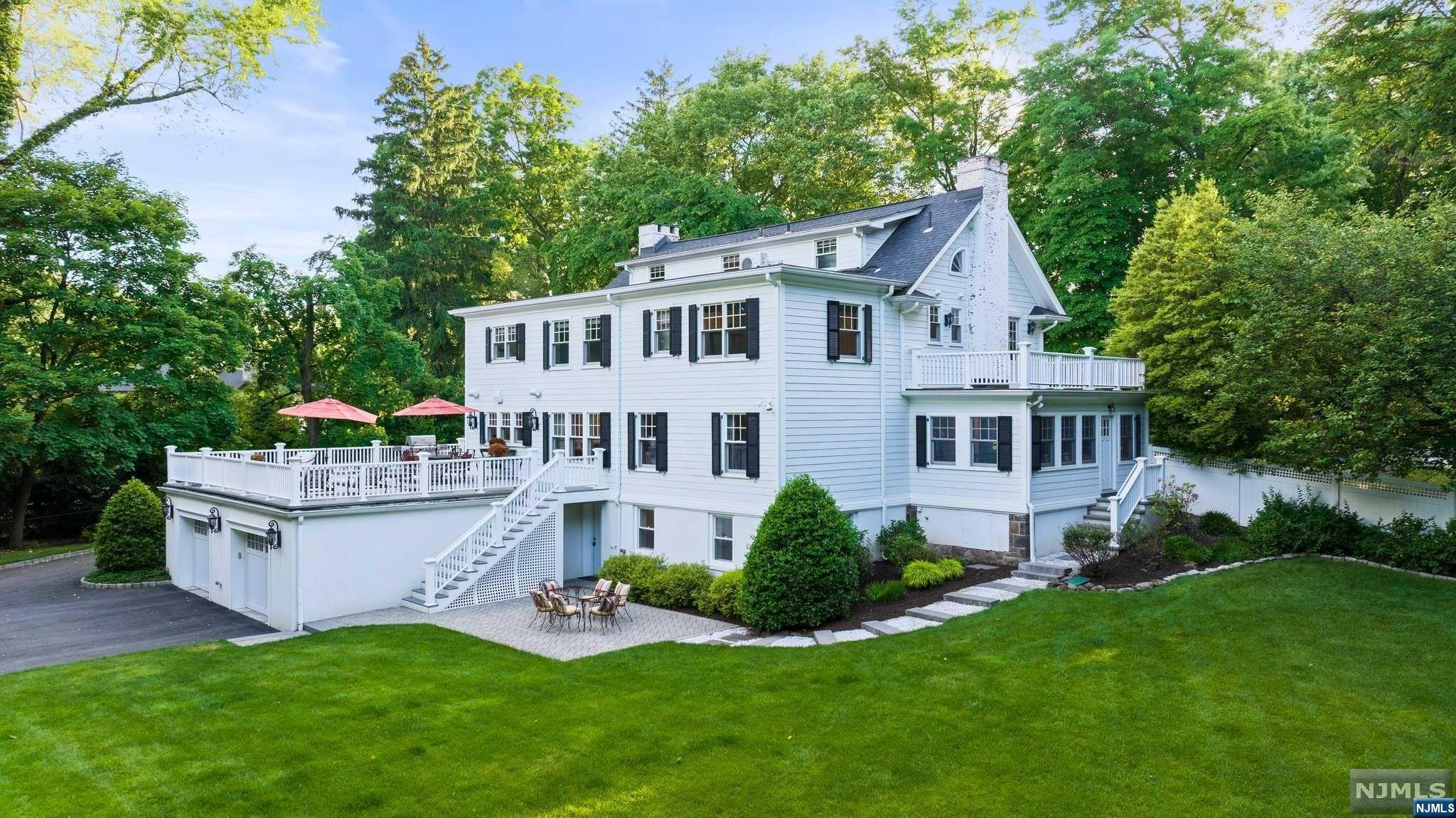 Please view virtual tour. This luxurious colonial home on an acre of land. Acclaimed schools, close to Manhattan, upscale shopping and fine dining. Renovated and expanded by renowned architect Ken Nadler, featured in Architectural Digest. Designed for entertainment, the main level seamlessly connects indoor and outdoor living. Gourmet kitchen opens onto a bluestone patio with scenic backyard views. State-of-the-art sound system in most of the rooms on the first floor and the primary suite. Fireplaces in the billiard room and dining room. Upstairs, the primary suite features dual walk-in closets and a spa-like bathroom. The ground floor has a summer kit, gym, extra bedroom, and bath, and access to the outdoor oasis, with attached and detached garages, white pebble walkways, and a fully fenced backyard. The grand circular driveway leads to the front entrance or to the back courtyard, allowing for ample parking. Seller has NJ real estate license. Call tod