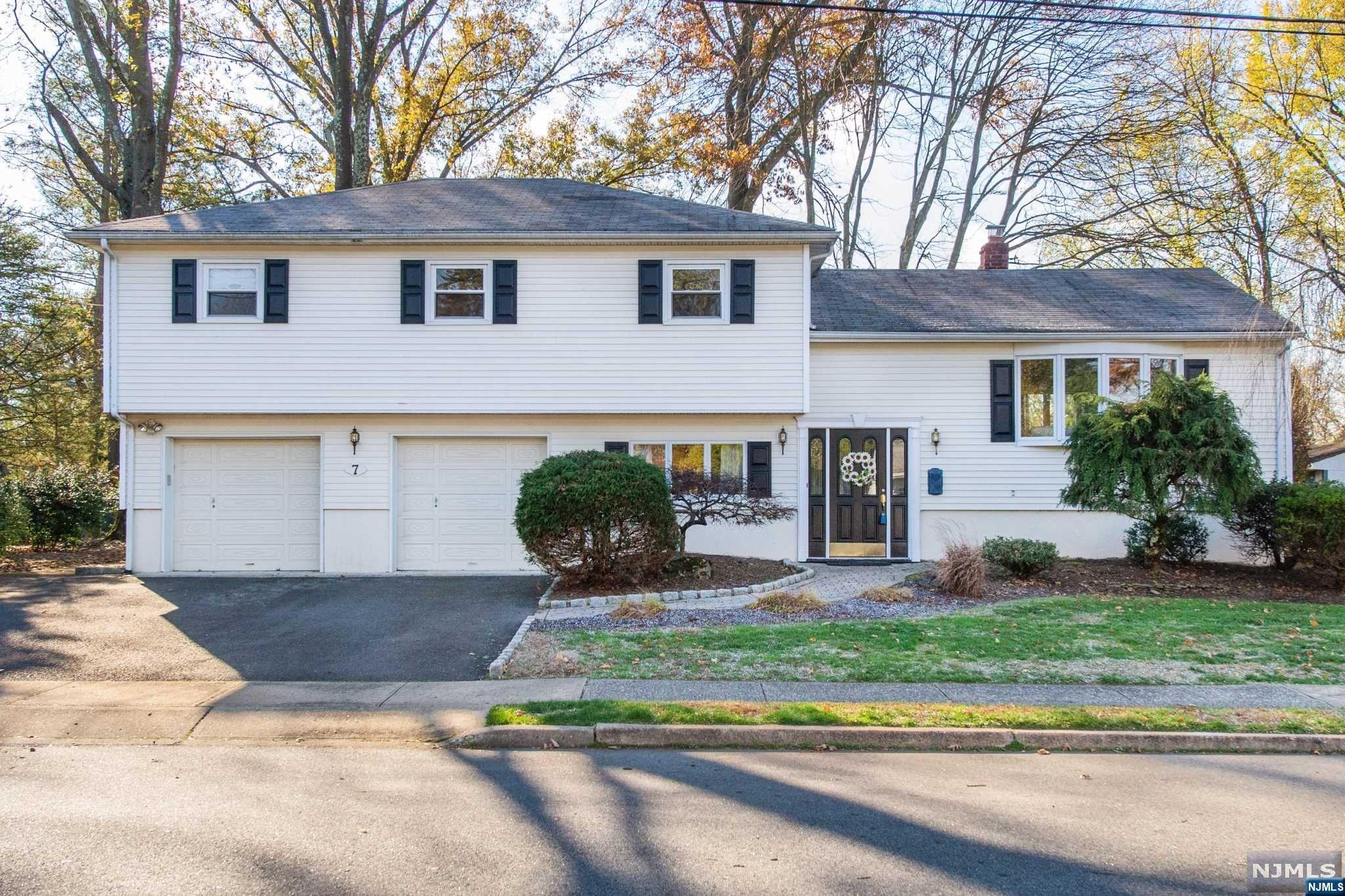 Split-level home with endless possibilities to suit your lifestyle. Sitting on a tree-lined street in one of Wayne's best neighborhoods, this home offers tons of space adaptable to all your needs. Inground pool, huge yard and great outside space to boot. As you enter the home you are greeted w/an open floor plan. The large living room & dining room have gorgeous HWFs & a bay window looking out to neighborhood. The EIK has lots of counterspace, laminate floors, pantry & 2 sliding glass doors to huge wrap around deck! Off the kitchen is the family room with fireplace, HWF and slider to the outside patio. Then head into the playroom/office or even an in-law suite with full bath & garage entrance. The second floor offers 3 bedrooms plus a nursery or convert that into your dream WIC! The main bedroom has a half bath, but could easily be converted into a full bath utilizing the current WIC. Over-sized garage offers endless possibilities are endless but it all starts w/dream location