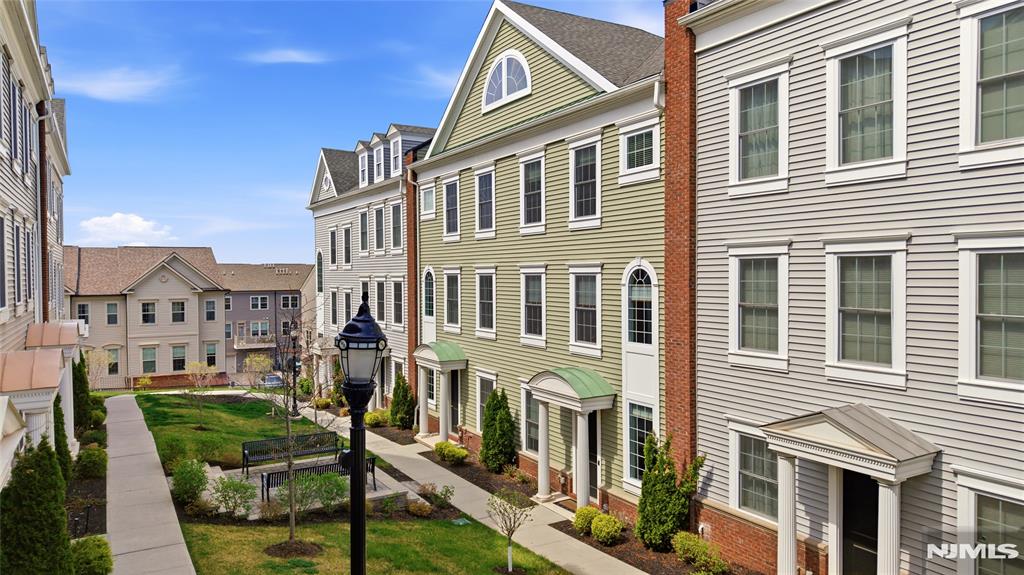 Call Charmy Morzaria at 609.619.2198 to see the home. STUNNING Colonial Style Luxury townhome located in FINEST & sought after Wright Place Community of Wood Ridge;ONLY 4 YEARS OLD has so much to offer;beautifully kept,tons of upgrades,has TAX ABATEMENT left! 30 mins from Manhattan,close to major turnpike/freeways,offers ease of commute to NYC,Hoboken,Jersey City,Secaucus;Wood Ridge has train station at Just 5 MINS stroll,also offers option of 2 buses going directly into Manhattan that runs every 10-15 mins.Beautifully manicured green lush lawn, colorfully arched flower walkway welcomes you in.This home includes front & rear entrance w/2car garage, 2 car driveway.1st floor has 9ft high ceilings,tall windows,2 closets,good sized 4th bedroom with a closet & full bath.Dramatically arched staircase will brings you to 2nd floor;open concept layout perfect for entertaining,10ft high ceilings,tall windows,massive dining space,modern Kitchen w/breakfast bar & Pantry, SS appliances,Quartz countertops, large living room w/outdoor deck offering.3rd floor offers primary bed suite w/full bath,his&her closets,2 add'l bedrooms,full bath & laundry room;2 Zone heating/cooling,hardwood floors throughout.Wood-Ridge has so much to offer;good schools,restaurants,coffee shop,liquor shop,pet grooming,phenix salon,sports field,parks & just steps away from TOP RATED Catherine Doyle elementary schools.A perfect home for buyers & a great investment option with high rent potential.