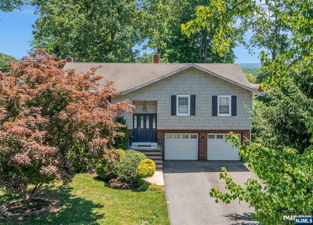 15 Sunset Pl, Emerson, NJ Updated 4 Bedroom 2 bath Bi-Level set on beautiful 75'x216' lot. Exceptional location. Main level features a living room, dining room, and updated kitchen with sliding glass door to a large deck, plus 3 bedrooms and an updated hall bath. Lower level offers a family room with fireplace and sliding glass door to a covered patio, a 4th bedroom/office, updated hall bath, laundry/utility room, and 2-car garage. 3-zone baseboard hot water heat, one-zone central air. Close to NYC commuter train and buses, parks and shopping. Don't be late for this amazing homeâ€”make it yours.