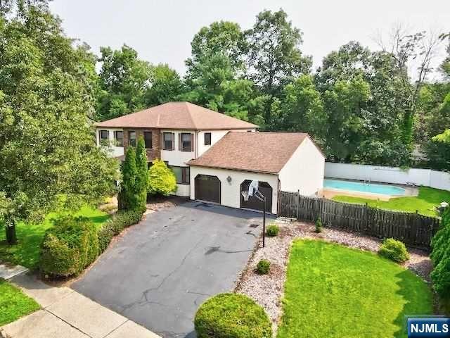 This classic center hall colonial is on a premiere tree-lined street in Black Oak Estates. The yard space is abundant with a multi-tier deck, gazebo, in ground pool and grassy areas. There is an abundance of windows to allow natural light to cascade in. As you walk through the front door and enter the foyer, the living room is to the left and dining room to the right. As you pass through the foyer you'll be in the large eat-kitchen and family room just past it. This level also has one bedroom/den/office, laundry room and half bath. The upstairs is the owner's retreat. A huge master bedroom suite with walk-in closet sits on one end of the second floor, with three additional bedrooms and full bath down the hall. The basement level has abundant storage and high ceilings, an ideal area to finish off and create additional living space.