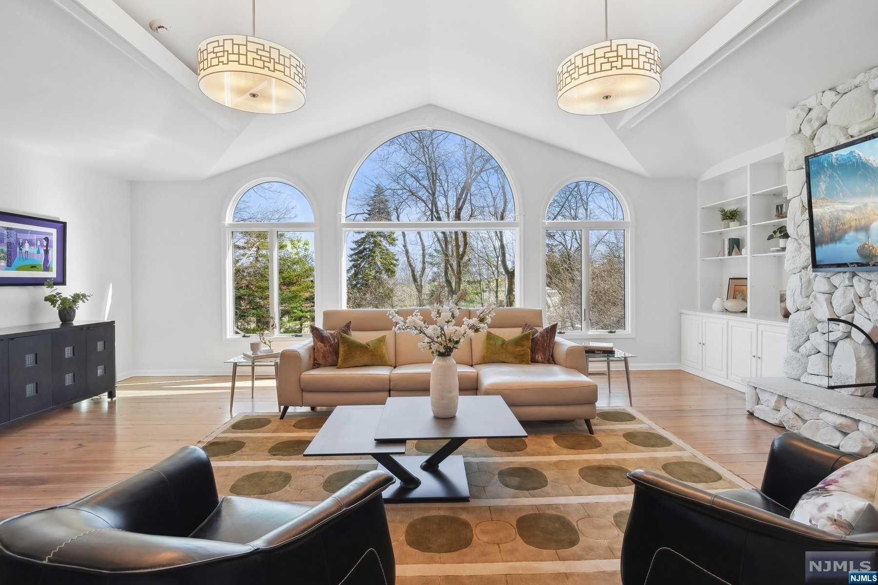 This stunning home offers breathtaking views of the New York City skyline. Fully updated, the main level boasts a bright gourmet kitchen equipped with top-of-the-line appliances and opens onto an expansive deck. The sun-filled great room features a vaulted ceiling, a wall of windows, and a dramatic stone hearth gas fireplace. On this level is also a formal dining room with fireplace, cozy living room with NYC views, powder room, laundry, and direct access to the two-car garage for added convenience. Upstairs, a beautiful primary suite complete with a newly updated bath w/ a soaking tub and walk-in closet awaits. There is another full bath and two more generously sized bedrooms. The lower level of the home offers even more living space, including a full bath, a sitting room, gym, and another bedroom/office with a separate entrance. This unique property provides ample storage, a whole-home generator for peace of mind and is perfectly situated close to all that Montclair has to offer
