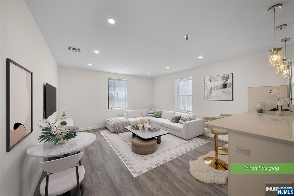 A rare opportunity to own a move-in-ready corner residence at Engle Street Commons, a charming historic Art Deco Art building in the heart of Downtown Englewood. This beautifully renovated 790 sq. ft. one-bedroom, one-bath home overlooks the Englewood Public Library and Renaissance Building, offering timeless character with modern updates. A welcoming entry foyer opens to a bright living and dining area filled with natural light from oversized windows. The renovated open kitchen features quartz countertops, newer appliances, and a breakfast bar. The spacious bedroom offers generous walk-in closet space, while recent upgrades include a new HVAC system, new water heater, and central air conditioning. Residents enjoy a secure, well-maintained building with an elegant hexagonal lobby, decorative skylight, laundry facilities, storage, and an accessible rooftop deck. Low HOA of $295/month, low taxes of $4,677/year, and no special assessment make this home an exceptional value. Enjoy one of Bergen County's most walkable downtown locations, just steps from restaurants, cafÃ©s, boutiques, shopping, and the Englewood Public Library. NYC bus service is right outside the building, making this an ideal commuter location.