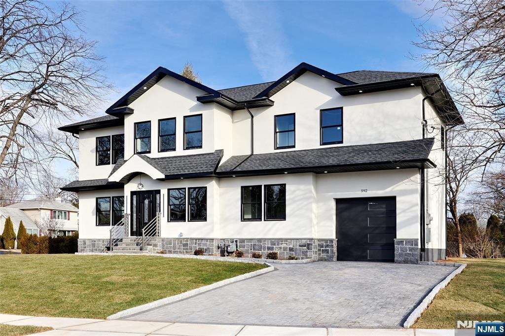 Modern 5-bedroom, 5.5-bath custom home in a prime New Milford location, offering exceptional space, design, and versatility. Featuring two primary suites and a fully finished oversized basement, this home is ideal for extended living, entertaining, or work-from-home flexibility. The open-concept layout showcases a sleek kitchen with stainless steel appliances, built-in microwave, and crisp white countertops, flowing seamlessly into spacious living and dining areas filled with natural light. Built with quality in mind, the home includes Andersen windows and doors, 2-zone central HVAC, and a durable exterior of stucco over Hardie cement board with natural stone accents. Situated on a quiet residential street close to schools, shopping, and major highways, this property offers both comfort and convenience.