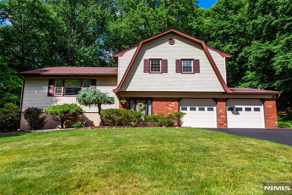 Beautifully maintained 3-bedroom, 2-bath split-level home located in the highly desirable Ringwood Acres section of Ringwood the only neighborhood in town served by public sewers. This inviting home offers a spacious and functional floor plan featuring a sun-filled living room, formal dining room, and an updated eat-in kitchen with abundant cabinetry and plenty of workspace. The upper level includes a generously sized primary bedroom, two additional bedrooms, and a full bath. The lower level provides exceptional living space with a warm and welcoming family room featuring a wood-burning fireplace, along with a dedicated office and recreation area perfect for today's flexible lifestyle needs. Step outside and enjoy your own private backyard retreat. A large deck and beautiful paver patio create the ideal setting for entertaining, outdoor dining, or simply relaxing in the peaceful surroundings. Mature trees provide natural privacy and a tranquil backdrop for year-round enjoyment. Additional highlights include a two-car garage, ample storage, and a prime location close to parks, lakes, hiking trails, schools, and all that Ringwood has to offer. Combining space, comfort, and convenience, this exceptional home is ready to welcome its next owner.