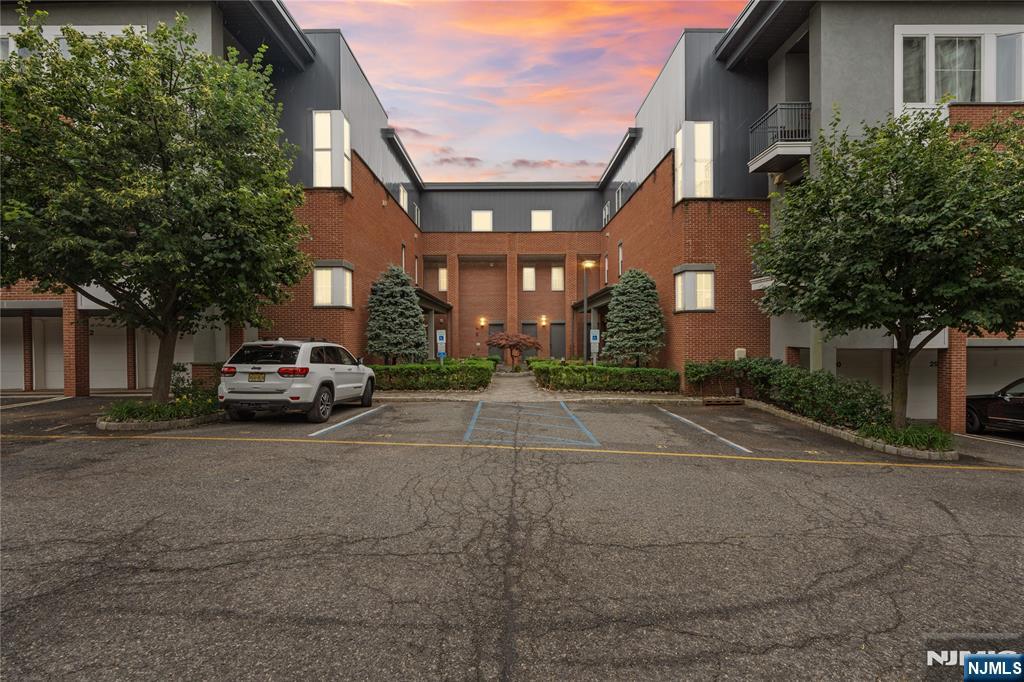 Welcome to Ridgeview on the Palisades, a sought-after boutique townhome community in a prime Fort Lee location. This modern 2010s-built townhome offers 3 generous bedrooms, 3 full baths, soaring 10-foot ceilings, gleaming hardwood floors, elegant crown molding, and a bright, open-concept layout ideal for both everyday living and entertaining. The main level features a spacious living room and dining area that flow seamlessly into a contemporary kitchen with stainless steel appliances, granite countertops, and ample cabinet space. A versatile bedroom and full bath on this level are perfect for guests, a home office, or multigenerational living. Upstairs, the primary suite feels like a private retreat, complete with a spa-style bath showcasing a double vanity, jacuzzi tub, separate shower, and rich marble finishes. An additional ensuite bedroom and a conveniently located laundry room complete the upper level. Two designated parking spaces add everyday convenience. From this central Fort Lee location, enjoy easy access to Hudson River waterfront parks, local shopping, dining, and multiple NYC commuting options. The property is also near highly regarded Fort Lee public schools, including Elementary School #1. Experience low-maintenance townhome living with modern finishes, a functional floor plan, and an exceptional Fort Lee address at Ridgeview on the Palisades.