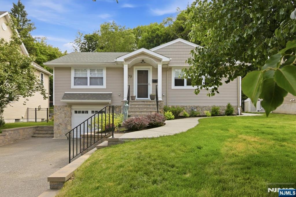 This beautiful ranch is move-in ready, and thoughtfully redesigned with an addition that expanded the home to include a spacious family room/dining area and private primary suite. Designed for easy one-floor living, the open and inviting layout offers a beautiful kitchen with granite countertops, center island, breakfast bar, and great flow for everyday and entertaining. Major added bonus features a finished lower level with a second full kitchen, full bath, laundry room, separate entrance, and additional sleeping or office area ideal for extended living, guests, or work-from-home space. Hardwood floors run throughout the home, adding warmth and continuity to the beautifully updated space. Stylish bathrooms feature elegant farmhouse-style sinks and quality finishes throughout, while the primary suite includes a large, luxurious stone shower with a built-in bench. The fully fenced and professionally landscaped backyard creates a private outdoor retreat with a paver patio. Additional highlights include multi-zone central air and forced hot air, laundry on both levels for added convenience, and a tandem two-car garage. Major improvements including the roof, siding, electrical, HVAC, and more are all less than four years old, offering peace of mind and modern efficiency. A move-in ready home combining comfort, style, and versatility in a sought-after neighborhood.