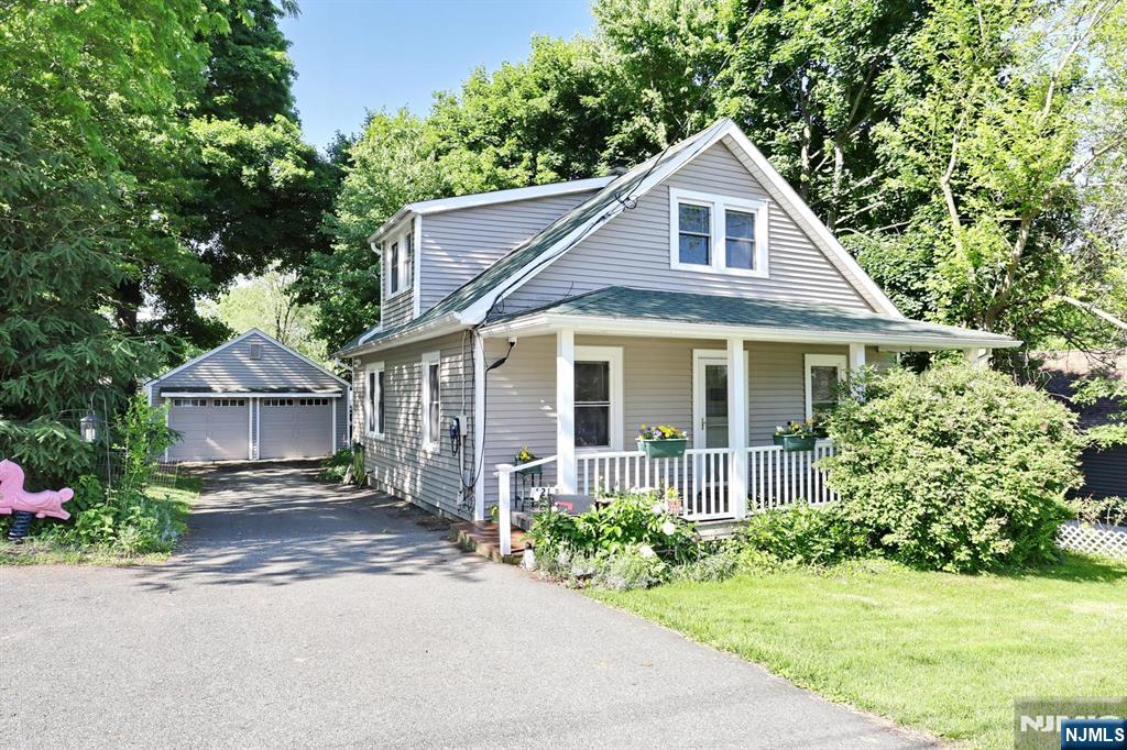 Charming 1924 Craftsman Cottage with Character, Flexibility & Room to Grow! Nestled on a quiet, tree-lined street in sought-after Mahwah, this beautifully maintained home sits on an oversized 75x100 lot and blends timeless charm with thoughtful updates and future potential. An inviting covered front porch welcomes you into spacious living and dining rooms featuring original wood floors, classic details, and warm, comfortable living spaces. Freshly painted and move-in ready, the flexible layout includes a desirable 1st-floor primary bedroom, 2 additional bedrooms, a dedicated office, and 2 full baths. The lower level offers a large, finished bonus room ideal for recreation, media, fitness, or work-from-home needs, plus unfinished storage/workshop space and a convenient quarter bath. Outside, enjoy a large detached 2-car garage, expansive driveway parking, mature landscaping, and generous yard space with opportunity for future expansion or customization. Conveniently located near top-rated, award-winning schools, houses of worship, shopping, dining, and easy NYC transit. Experience all that Mahwah has to offer, including low taxes, a popular town pool and recreation programs, and access to numerous local and county parks, trails, and outdoor amenities. 1-Year Home Warranty included. Classic Craftsman charm, practical living space, and exceptional lifestyle in one of Bergen Countyâ€™s most desirable communities.